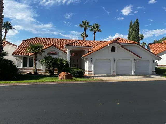 White stucco exterior with a terracotta tile roof