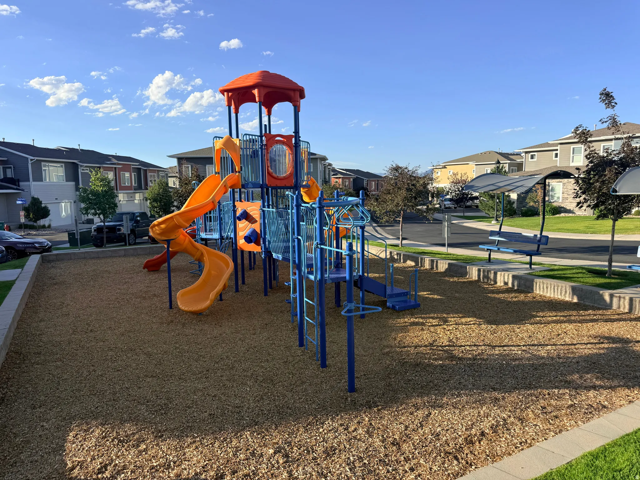 Community playground featuring a multi-level structure with slides and climbing elements