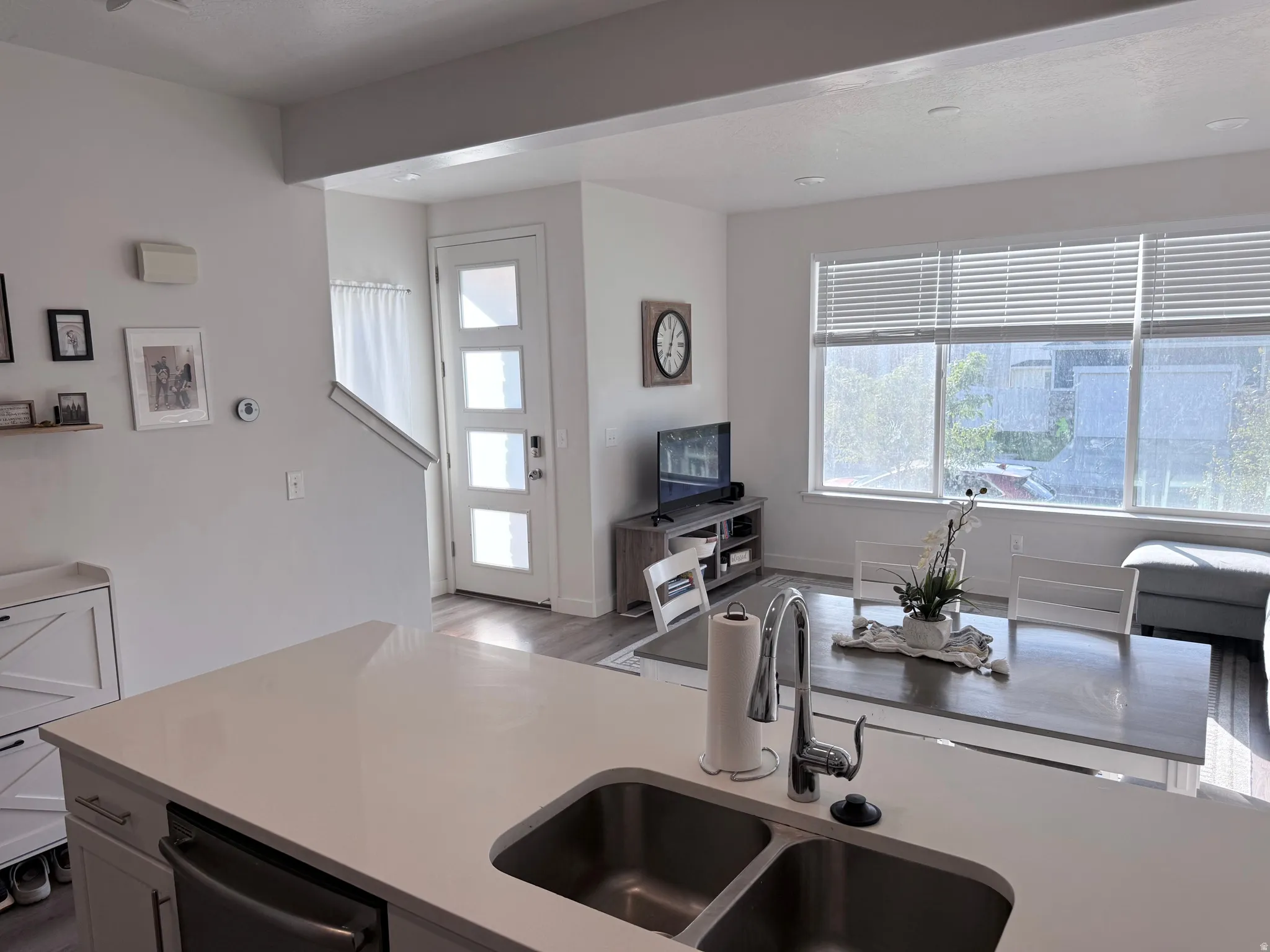 Kitchen island featuring an undermount double-basin stainless steel sink with a gooseneck faucet