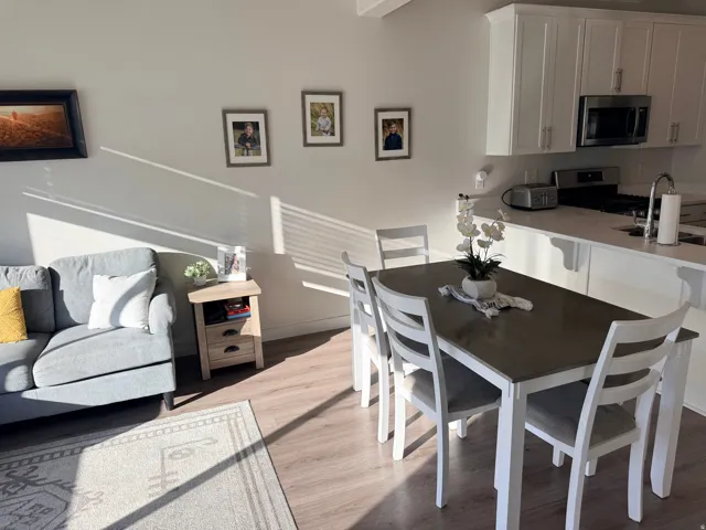 Contemporary kitchen featuring white cabinetry, stainless steel appliances, and a light-toned countertop