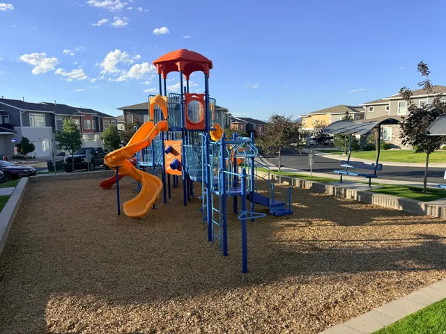 Community playground featuring a multi-level structure with slides and climbing elements