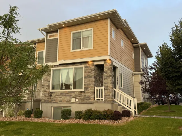 Contemporary multi-level exterior featuring stone veneer and horizontal siding
