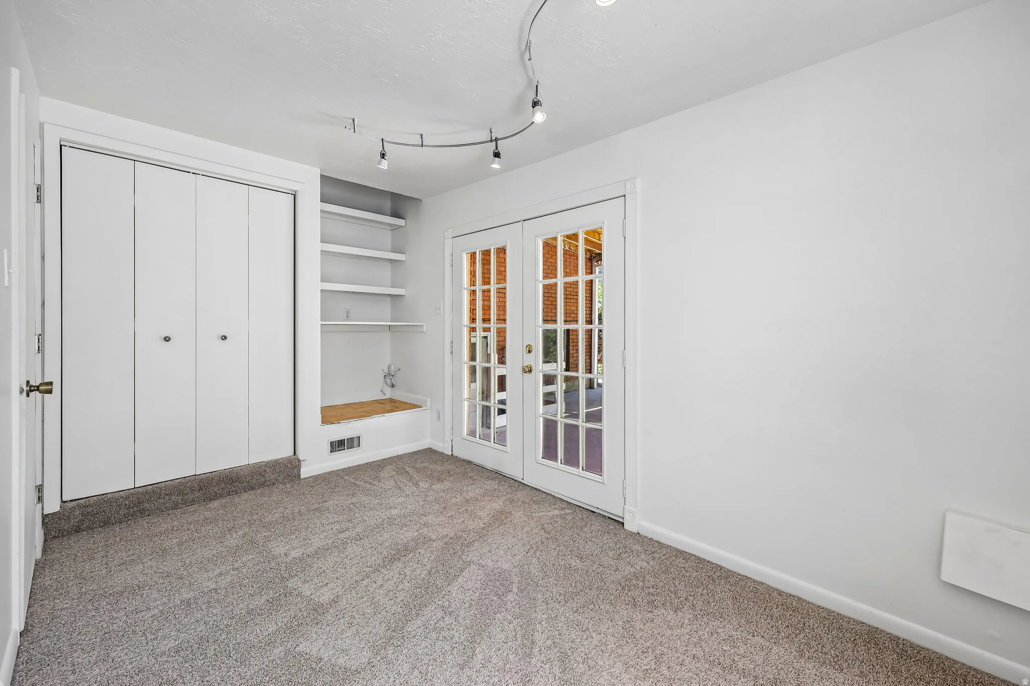 Light gray carpeting with a white baseboard trim
