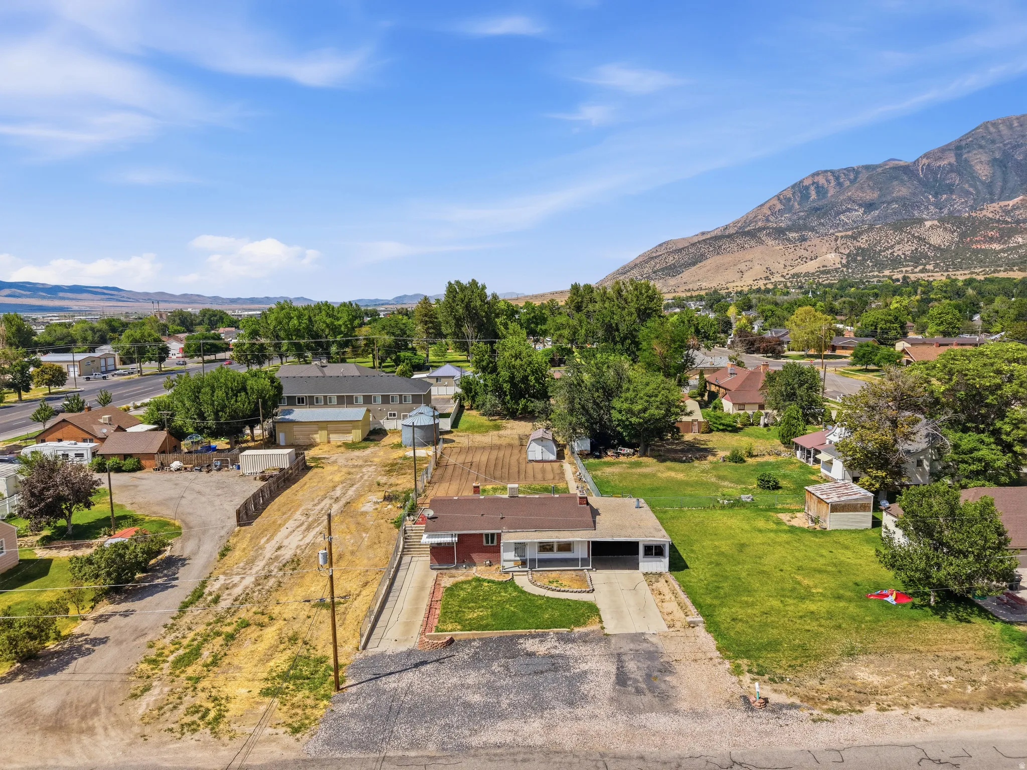 Ranch-style residence featuring a carport and front lawn