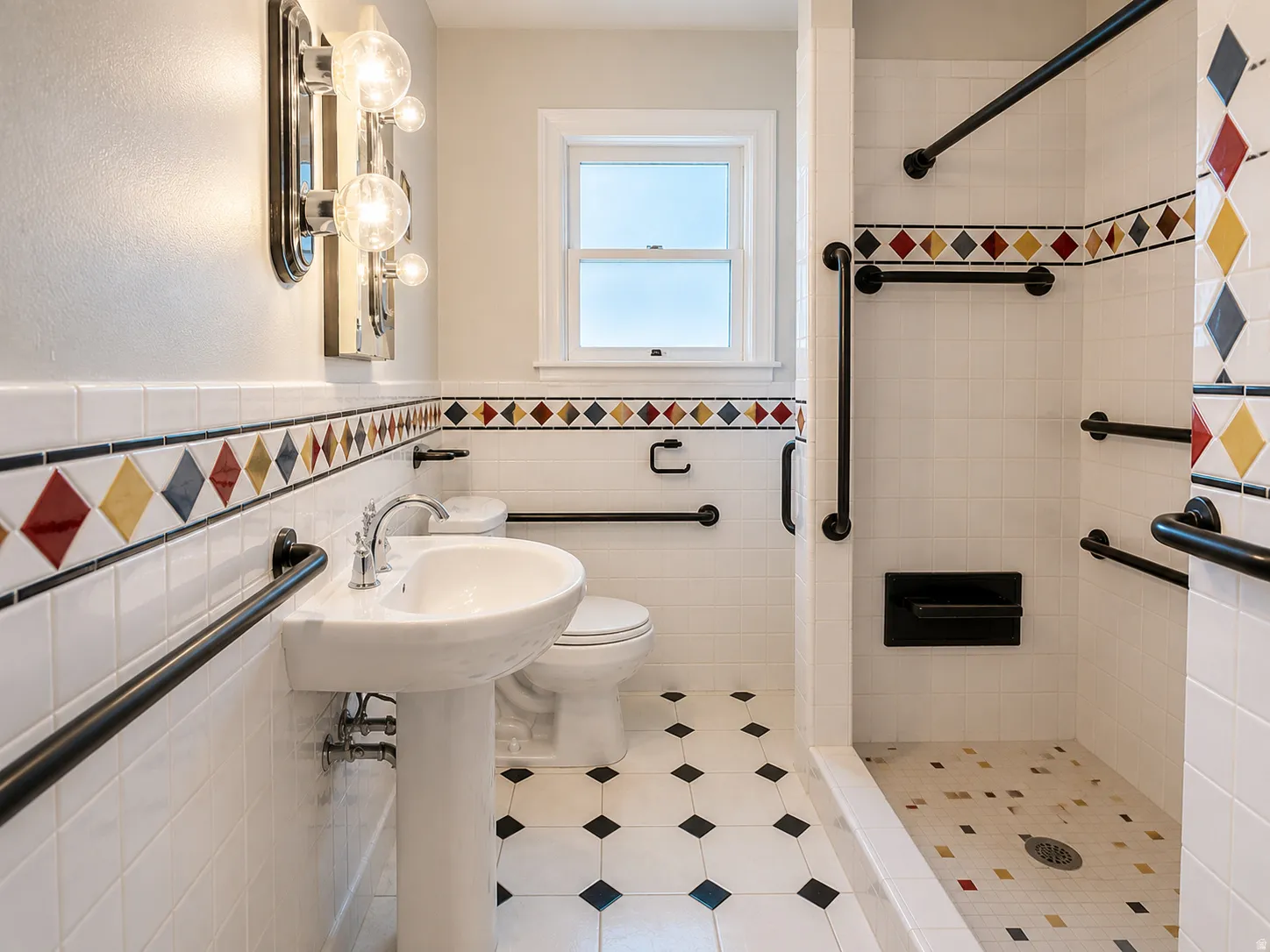 Pedestal sink with chrome faucet, tiled walls with decorative accents, walk-in shower with grab bars, and a window providing natural light