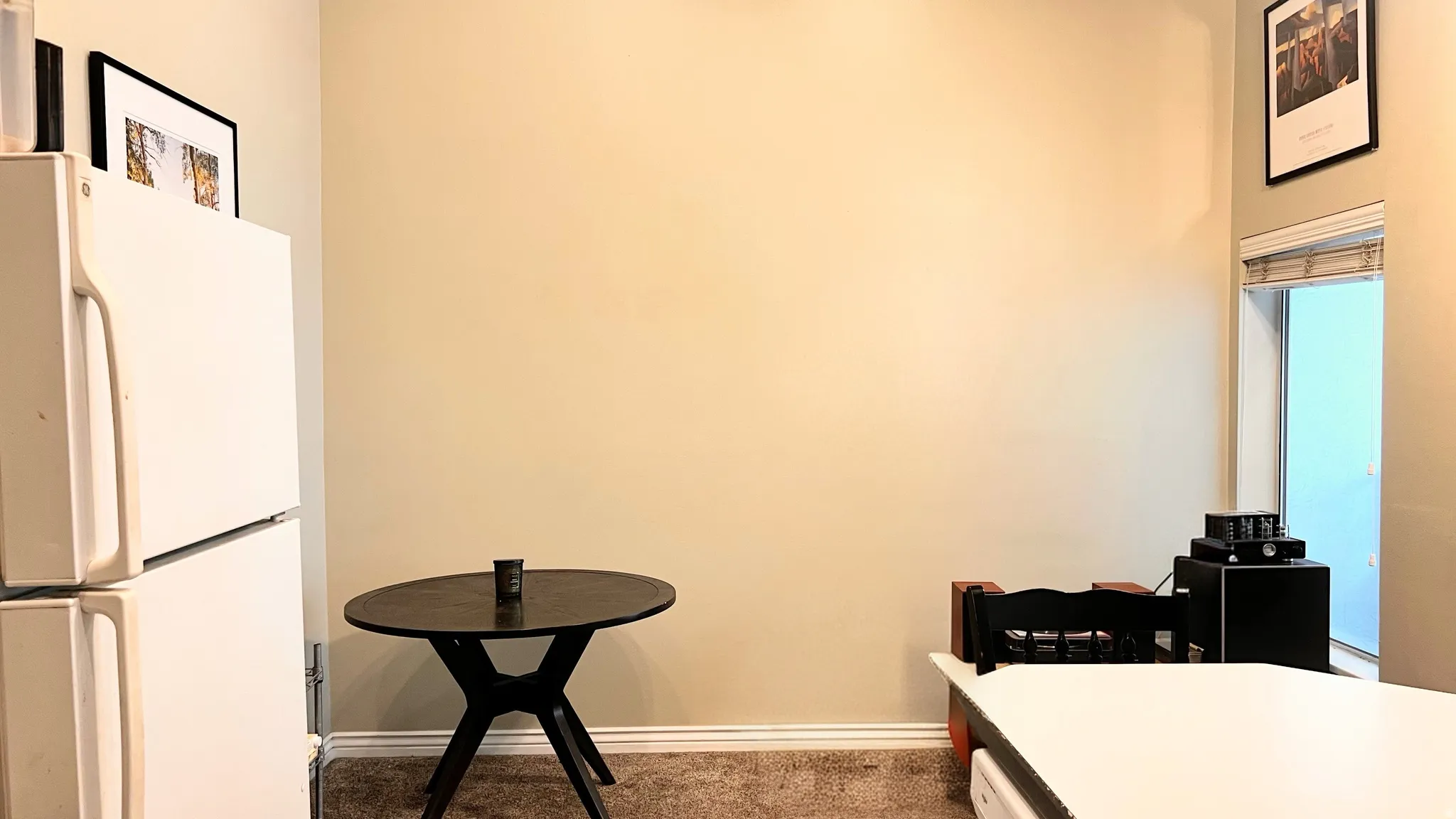 Warm neutral wall color featuring white trim and carpeted flooring