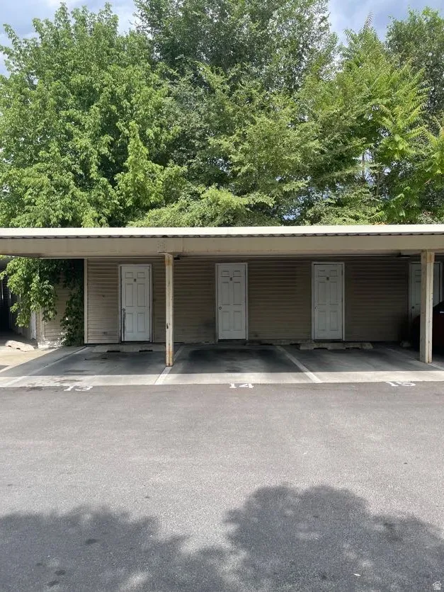 Covered parking structure featuring storage closet