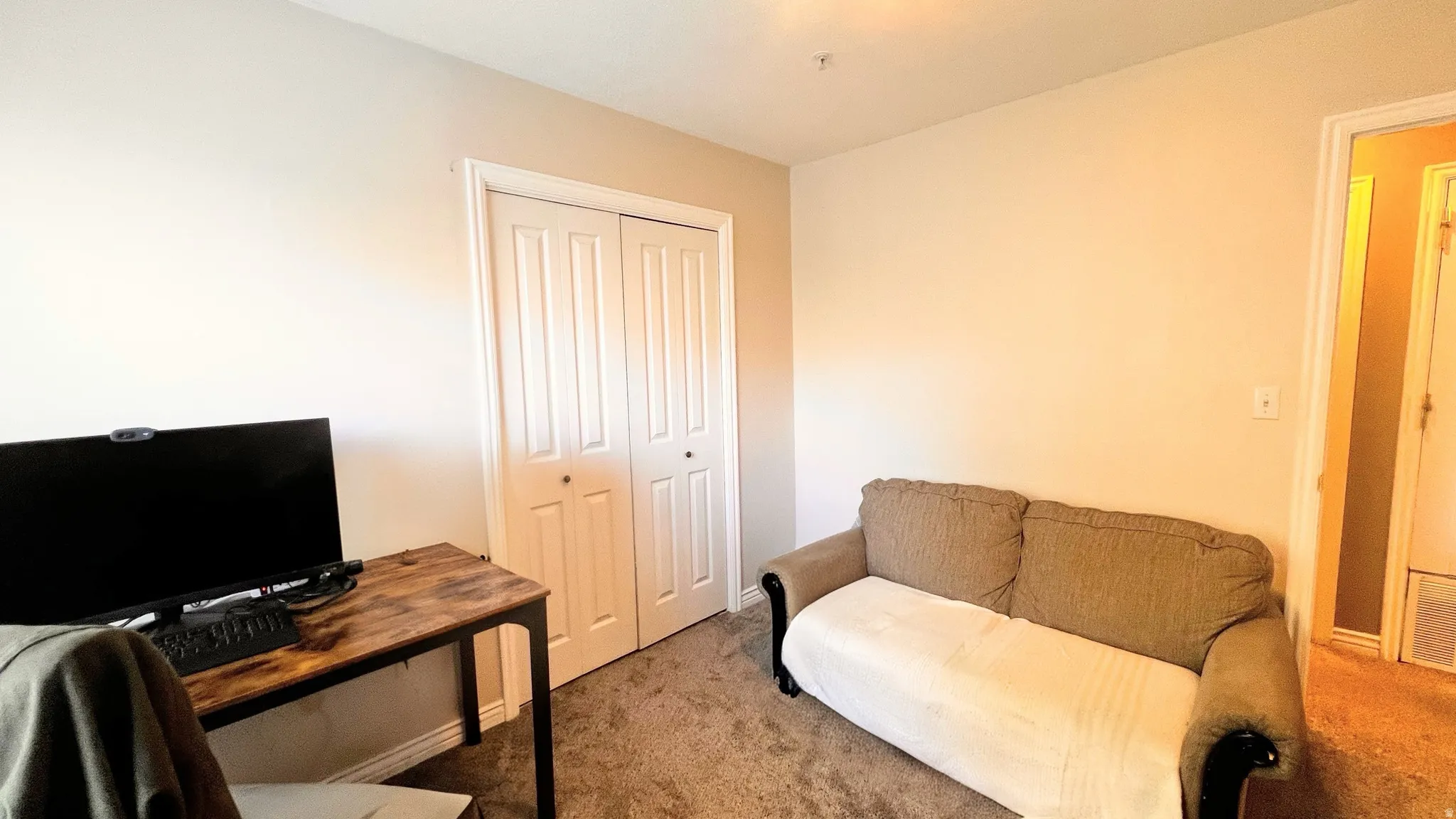 Neutral wall tones and carpeted flooring