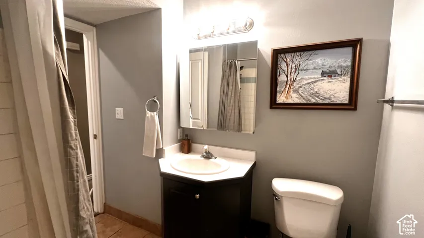 Bathroom vanity with an integrated sink, dark wood-finish cabinetry, and a chrome faucet