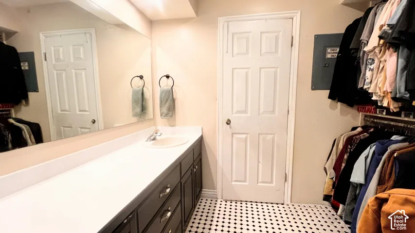 Master Bath with Elongated vanity with a single basin sink, silver-finish faucet, and substantial countertop space