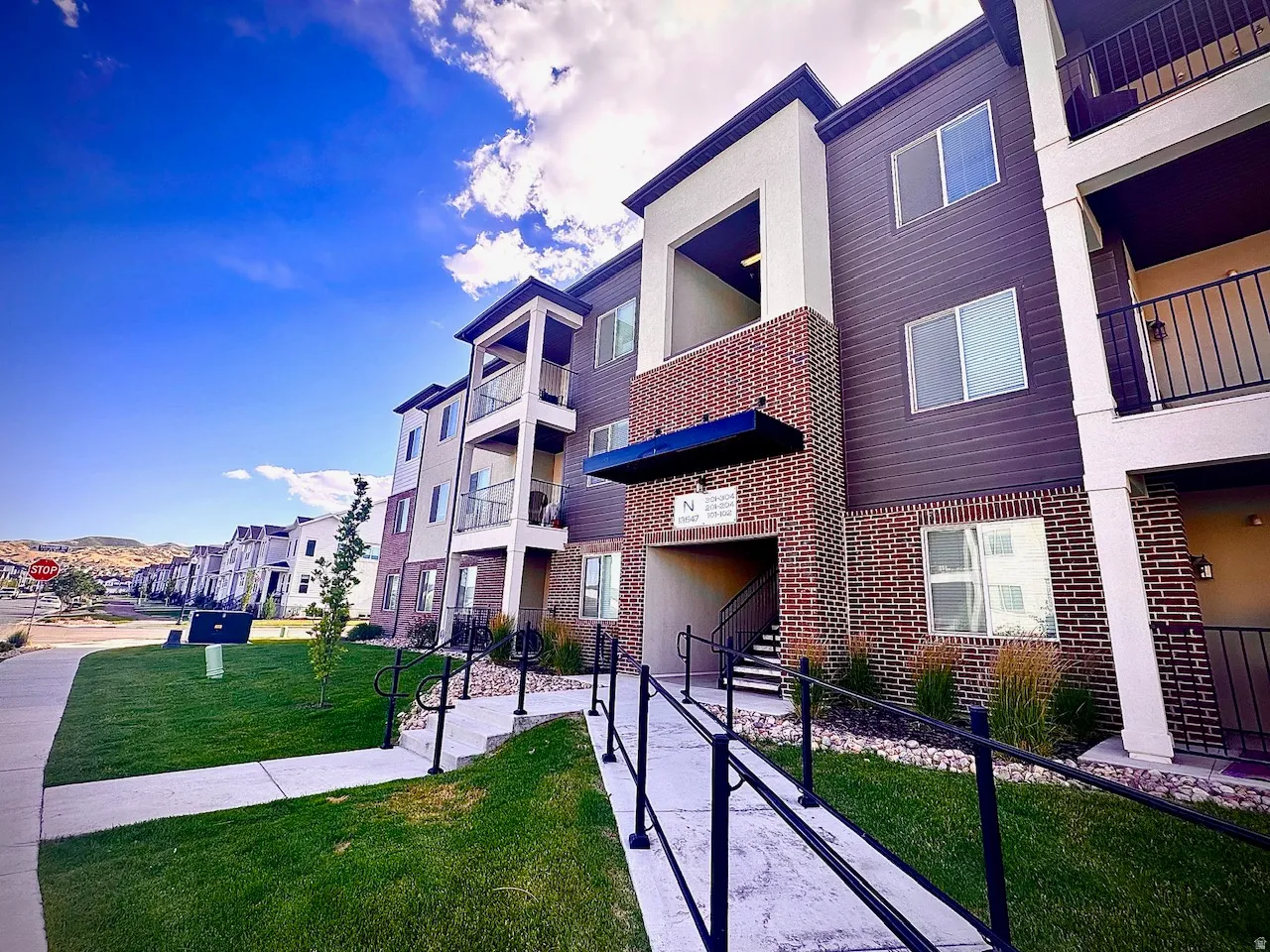 Modern multi-story building featuring brick and horizontal siding facades