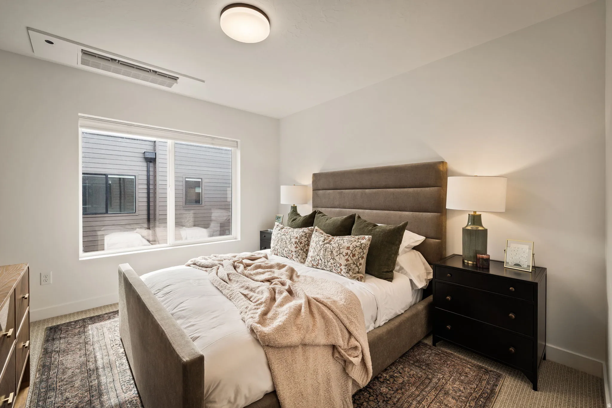 Bedroom featuring a large picture window, recessed ceiling light, and light-toned walls