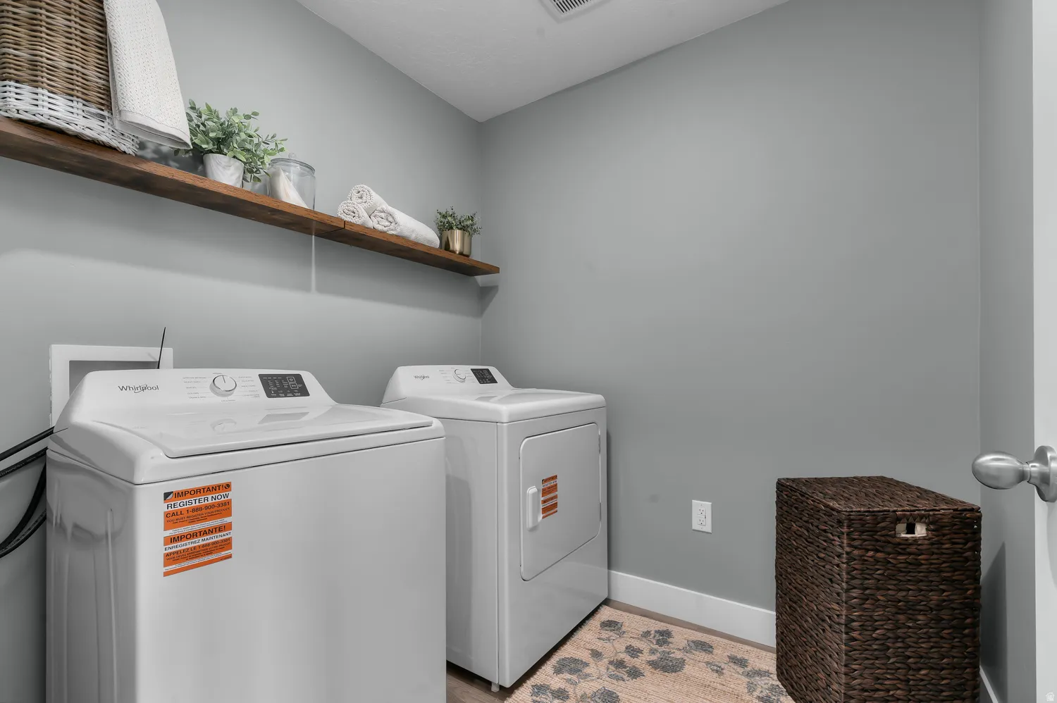 Dedicated laundry space featuring a white top-load washer and front-load dryer