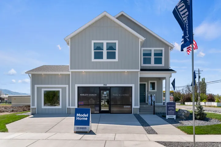 Contemporary two-story residence with light gray vertical siding and white trim accents