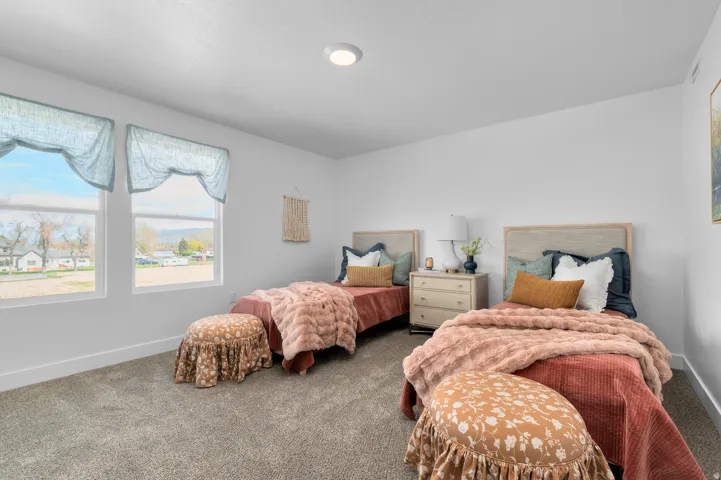 Bright room featuring two windows with valances