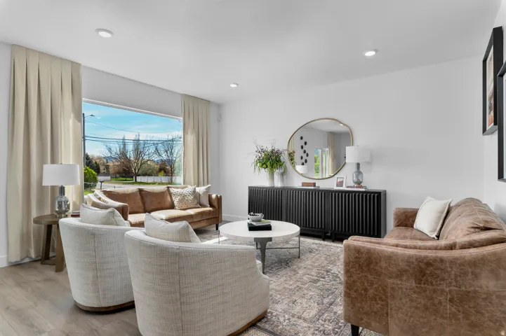 Living space featuring large picture windows, recessed lighting, and light wood-finish flooring