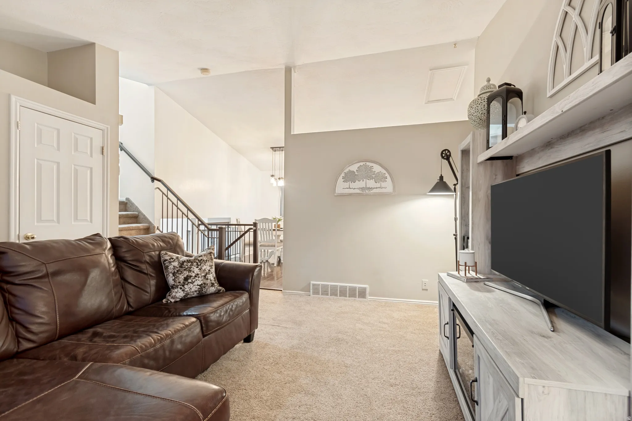 Carpeted living space featuring a built-in media center with shelving