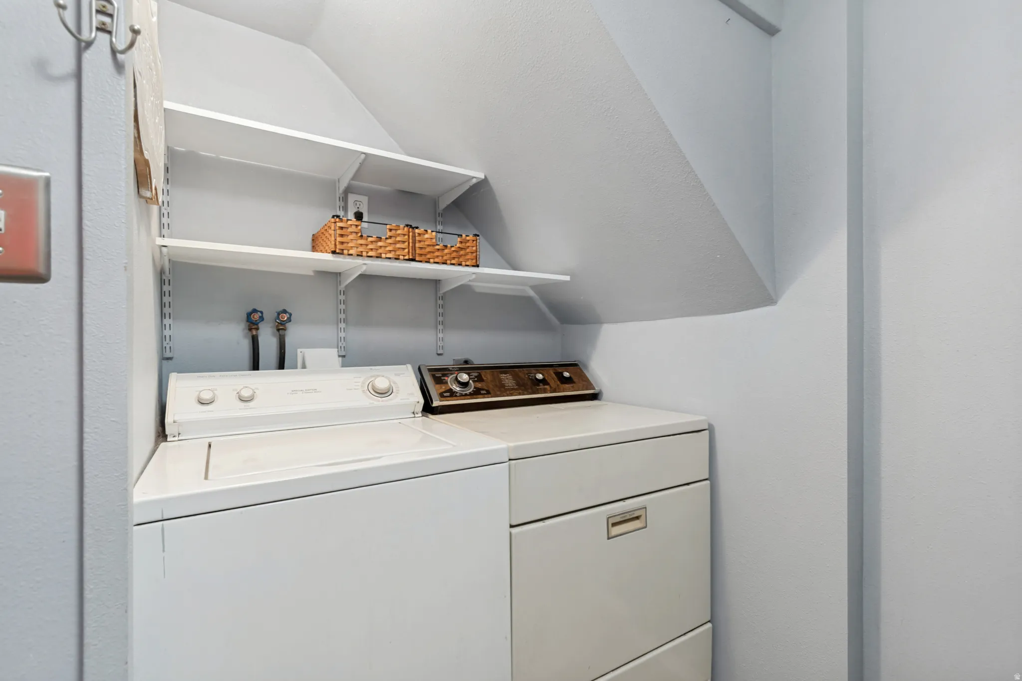 Dedicated laundry area featuring a white top-load washing machine and a white dryer