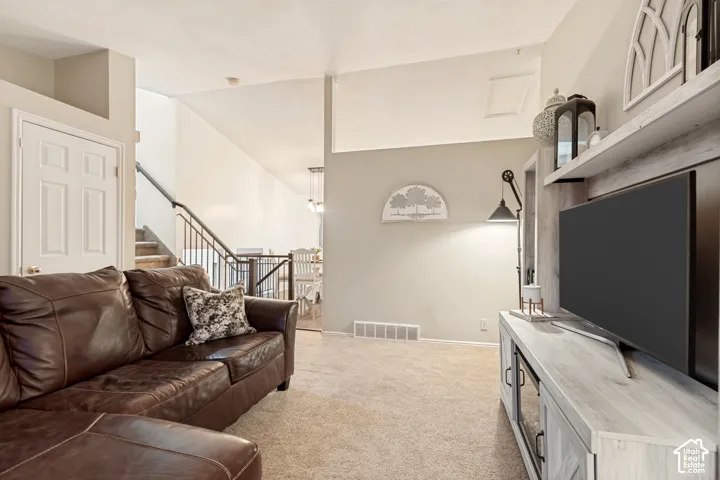 Carpeted living space featuring a built-in media center with shelving