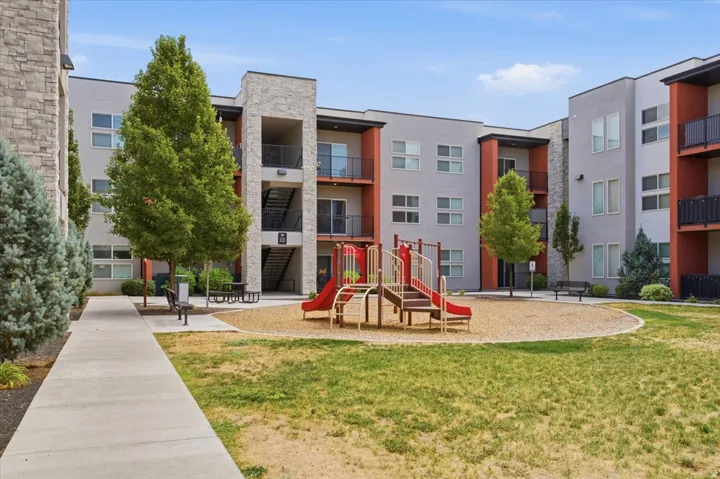 Exterior residential building featuring modern architecture, stone accents, and private balconies
