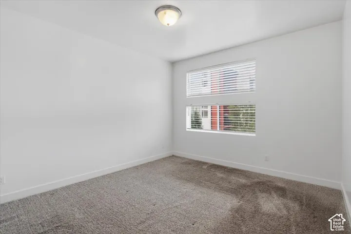 Bright room featuring two horizontal windows with integrated blinds