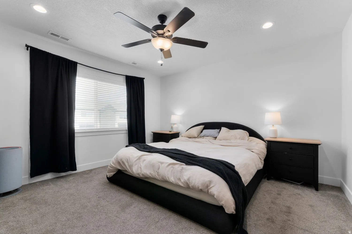 Bedroom featuring a ceiling fan with integrated lighting, recessed lighting, and a window with blinds and dark curtains