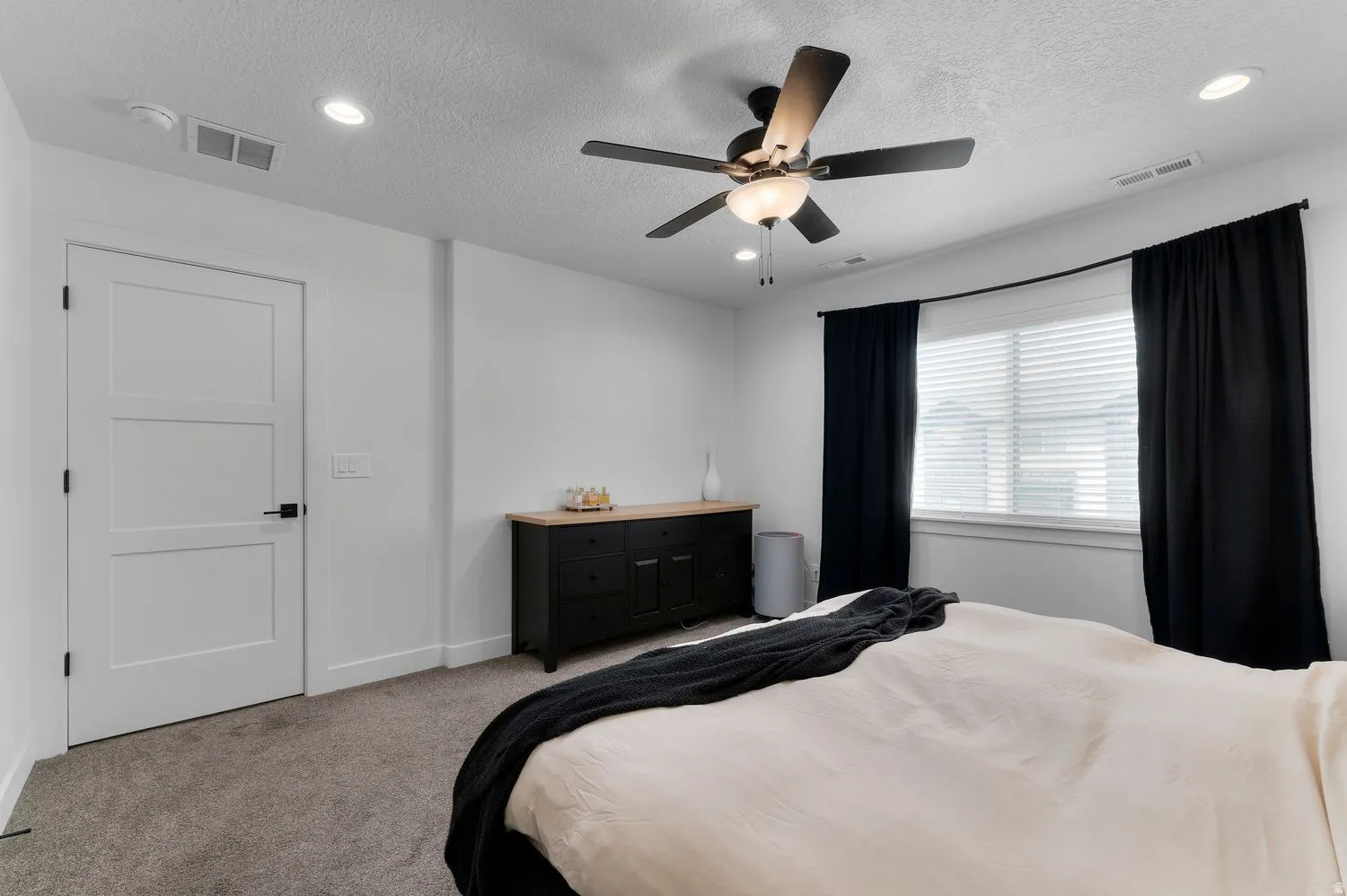 Neutral color palette featuring recessed lighting and a ceiling fan