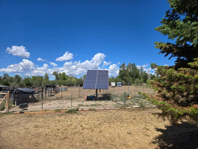 Solar panel array on a fenced parcel with a natural landscape