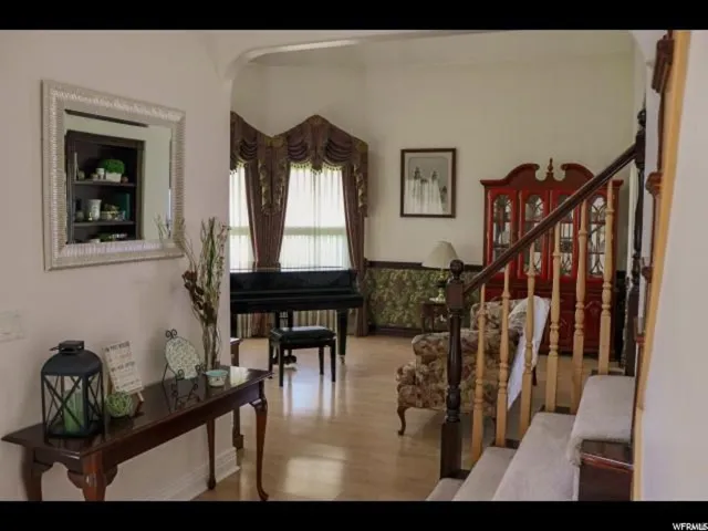 Hardwood-finish flooring extending into an arched entryway