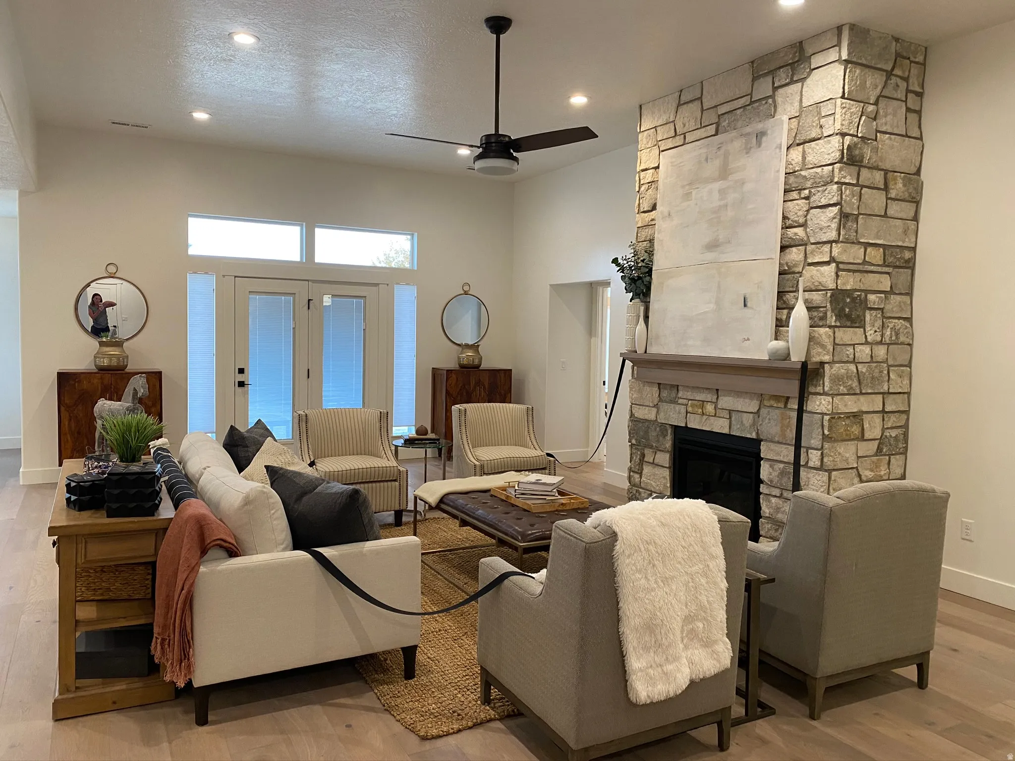 Stone-clad fireplace with a natural wood mantel