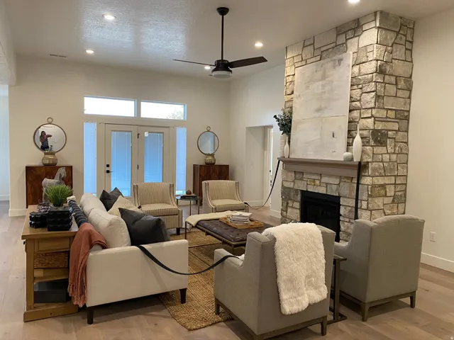 Stone-clad fireplace with a natural wood mantel
