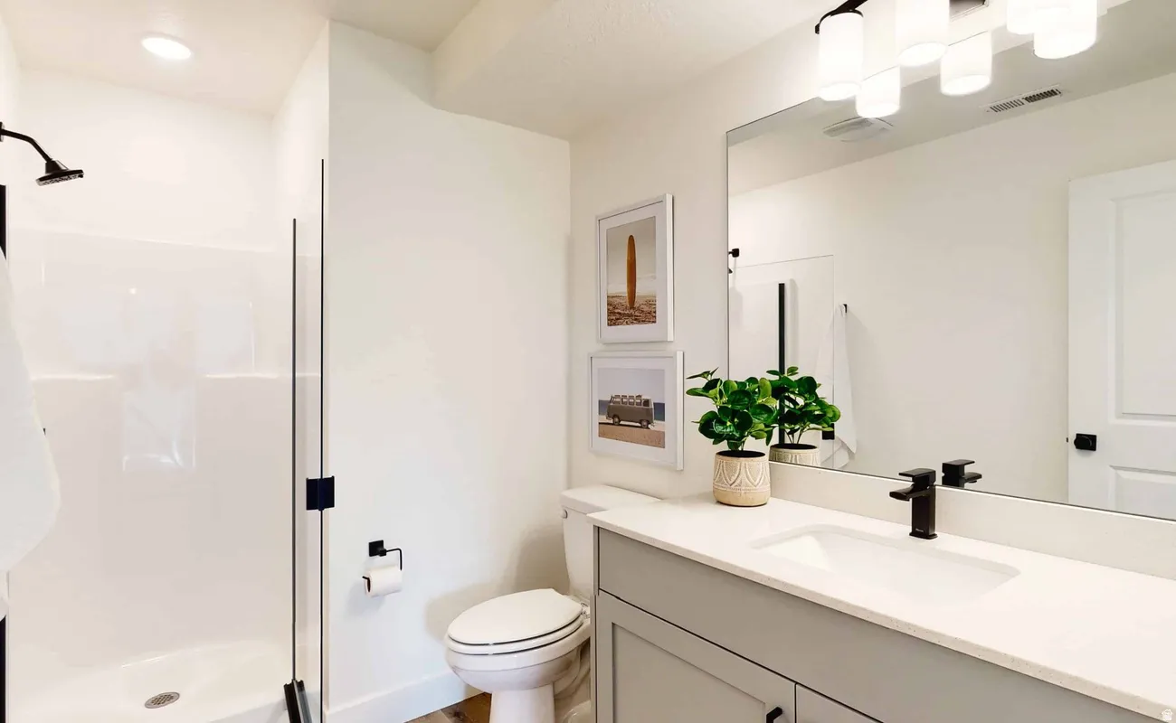 Bathroom featuring a light gray vanity with a white countertop and integrated sink