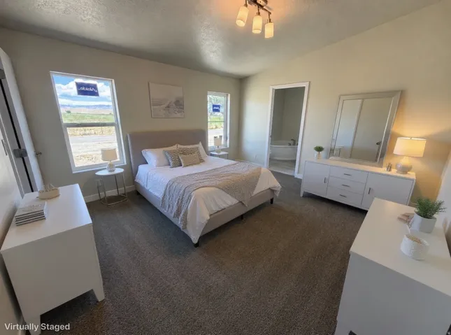 Carpeted bedroom featuring neutral-toned walls, two windows, and an overhead light fixture
