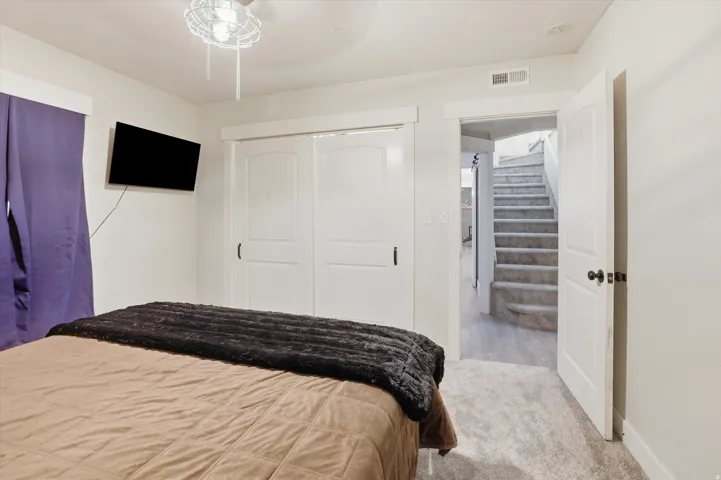 Bedroom featuring neutral carpeting and white painted walls