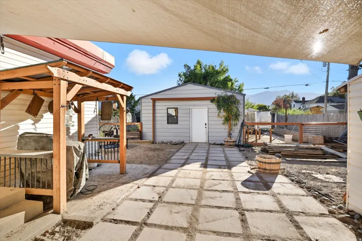Expansive outdoor area featuring a detached garage with a side entry door and a window