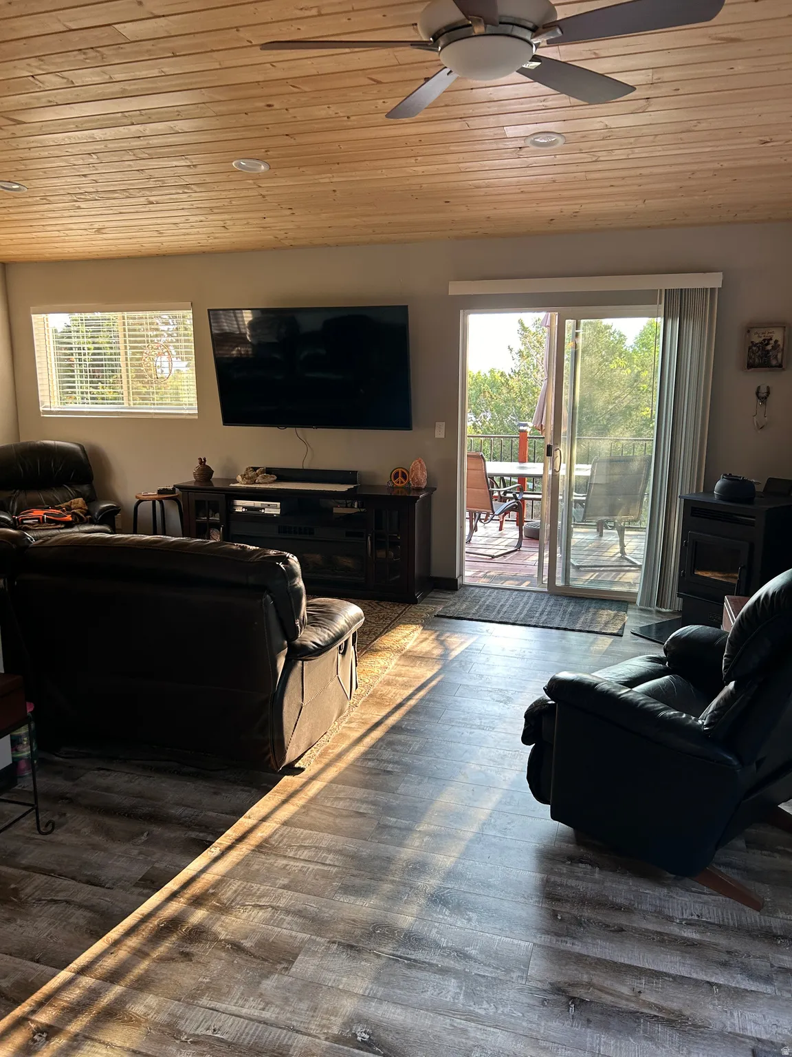 Living area featuring wood-finish flooring, a paneled wood ceiling with recessed lighting, and a ceiling fan