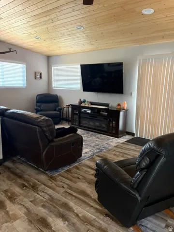Living area featuring wood-finish flooring and a wood-paneled ceiling