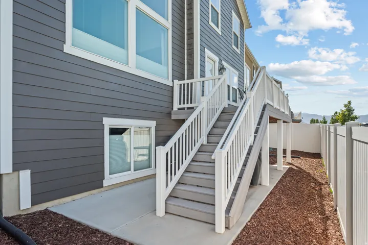 Multi-level deck with white railings and gray stairs