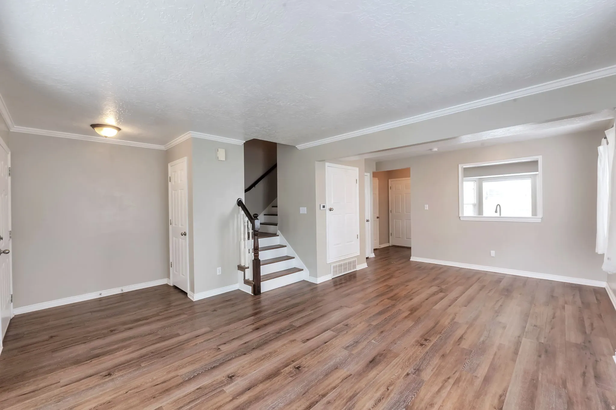 Window into kitchen for fun entertaining and open space feeling
