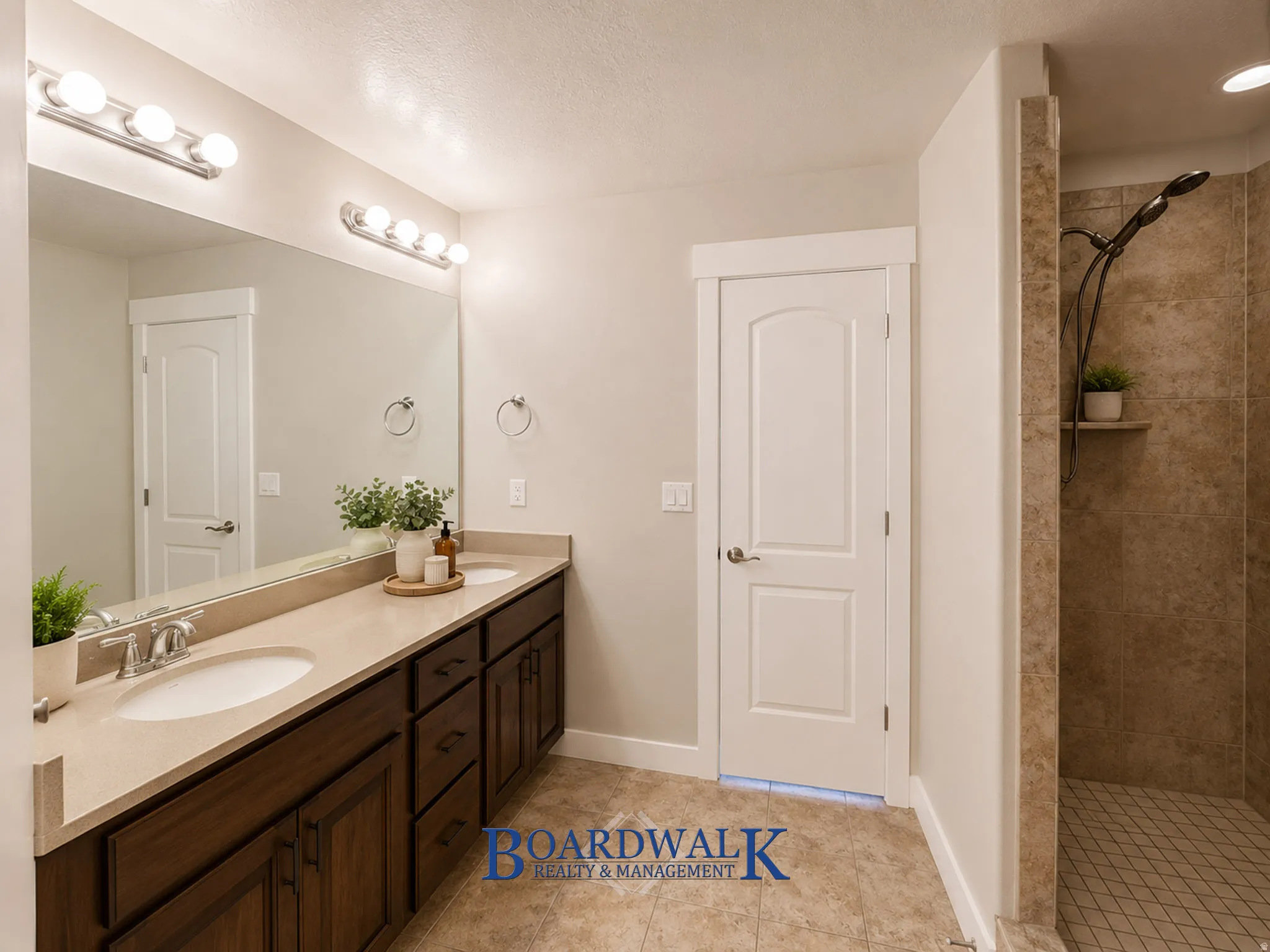 Bathroom featuring a dual vanity with dark wood-finish cabinetry and light-toned countertops