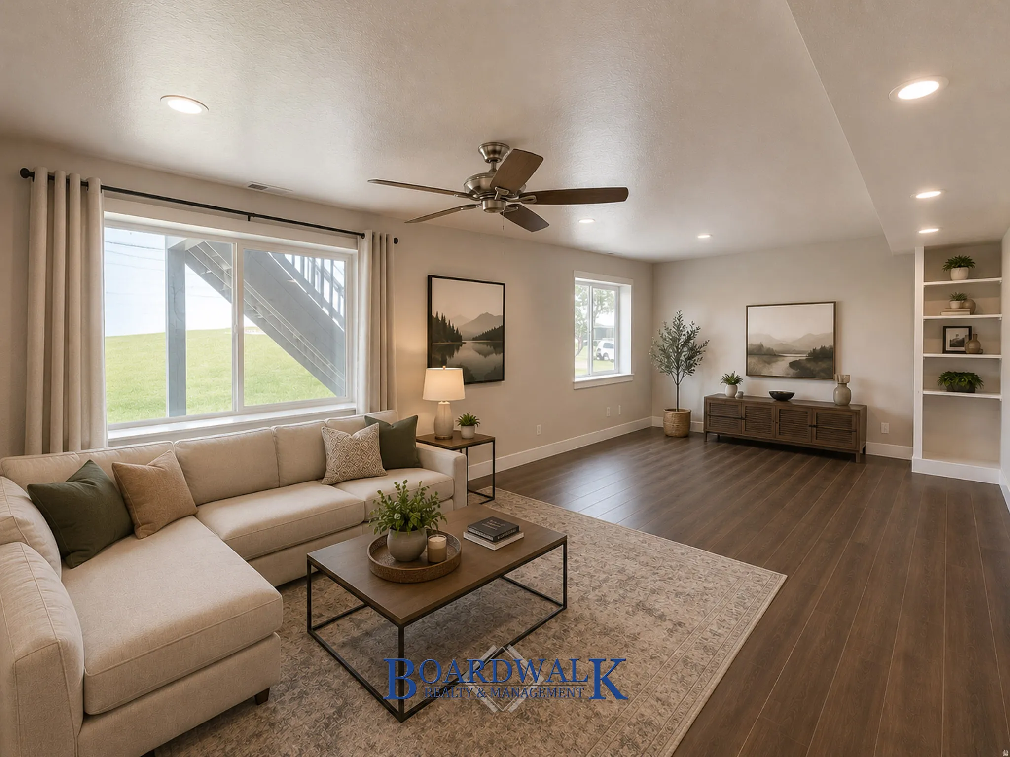 Spacious room featuring wood-finish flooring, recessed lighting, and a ceiling fan