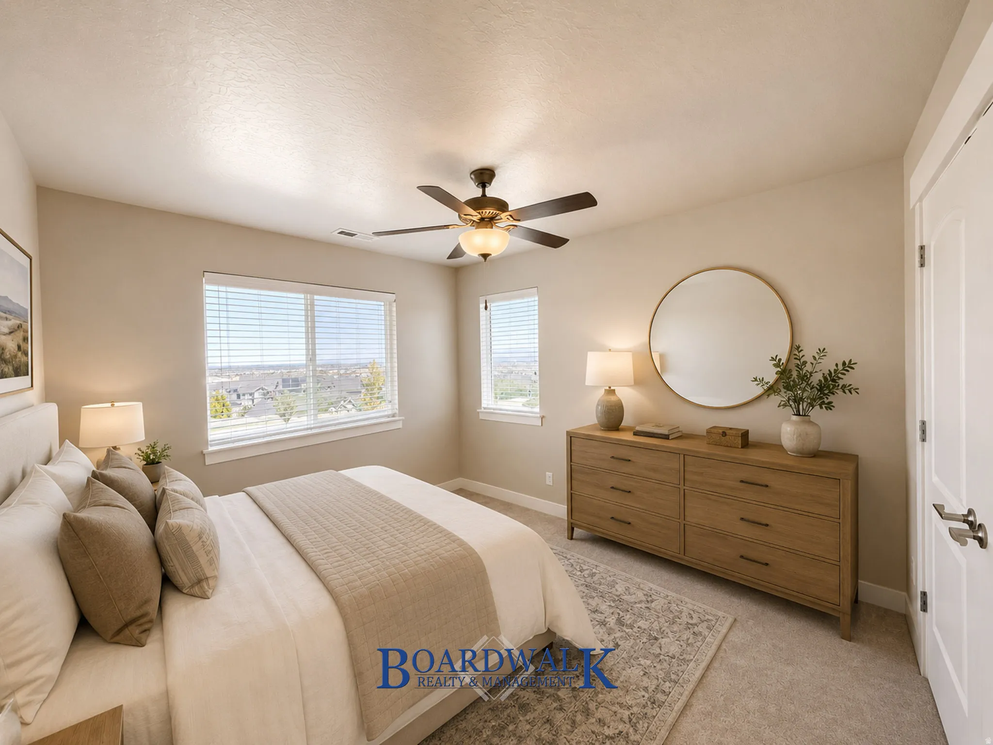 Bedroom featuring two large windows, a ceiling fan with integrated lighting, and neutral-toned wall paint