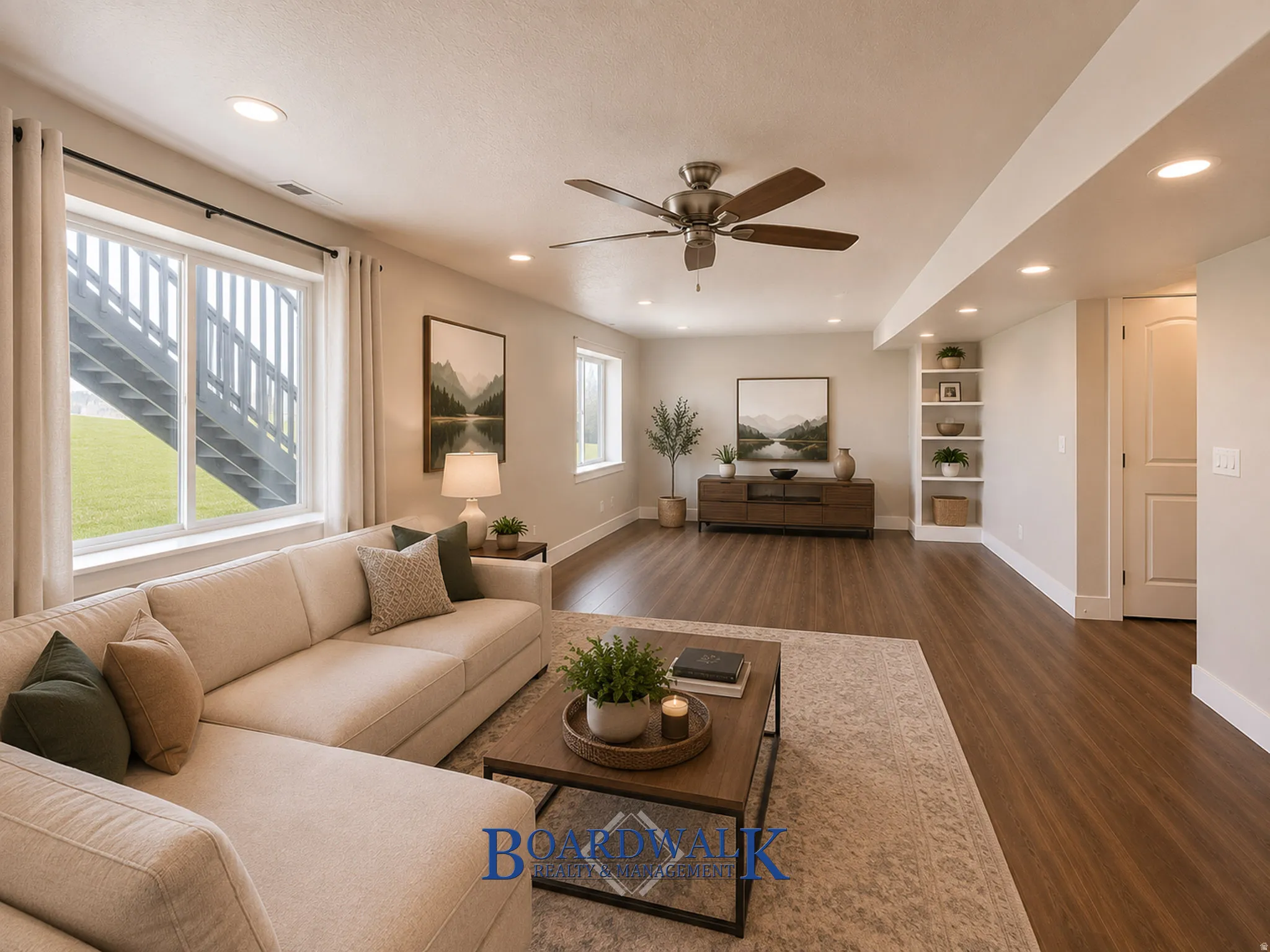 Spacious open-concept living area featuring wood-finish flooring, recessed lighting, and a ceiling fan
