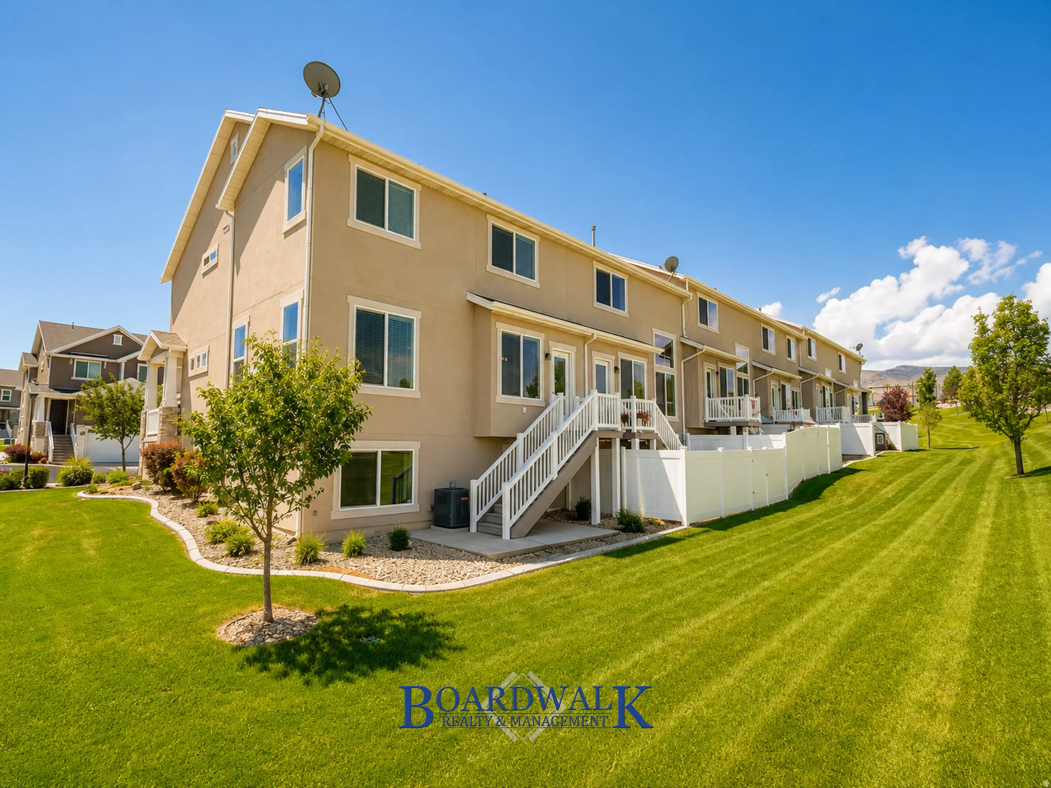 Townhome exterior with stucco siding and multiple windows