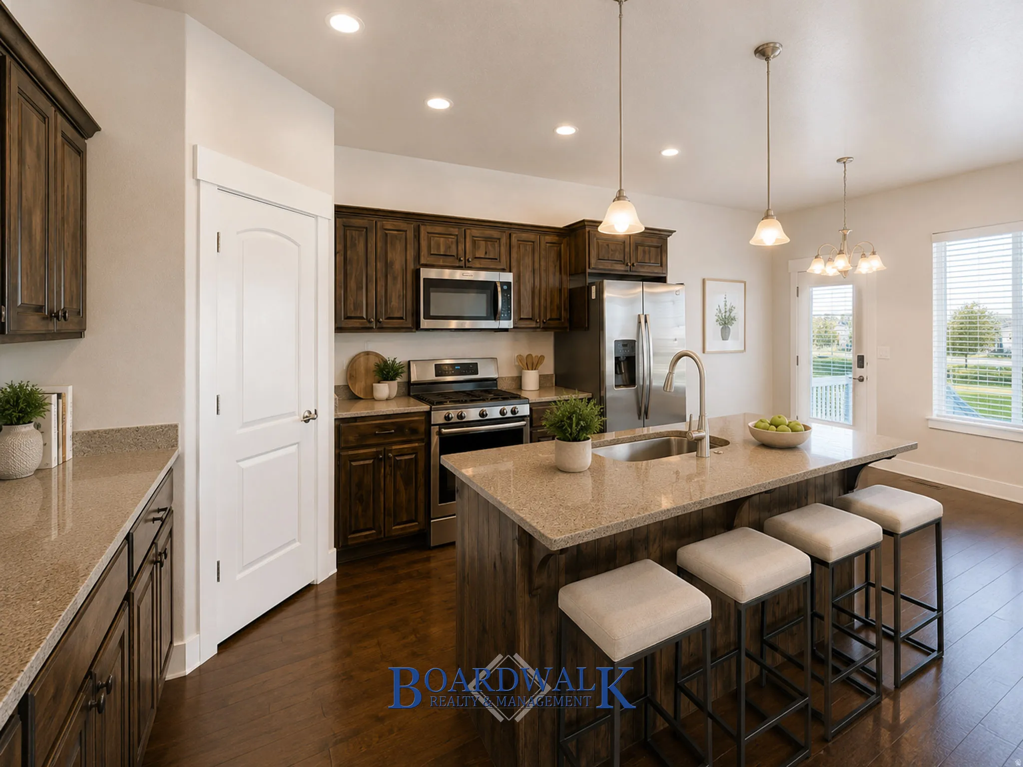 Kitchen featuring dark wood cabinetry, stainless steel appliances, and wood-finish flooring