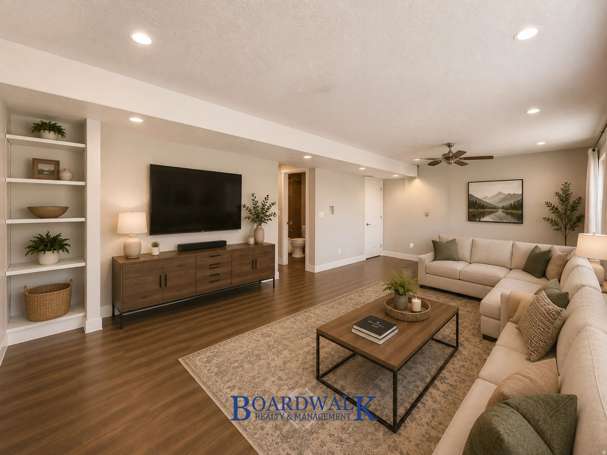 Spacious living area featuring wood-finish flooring, recessed lighting, and built-in shelving