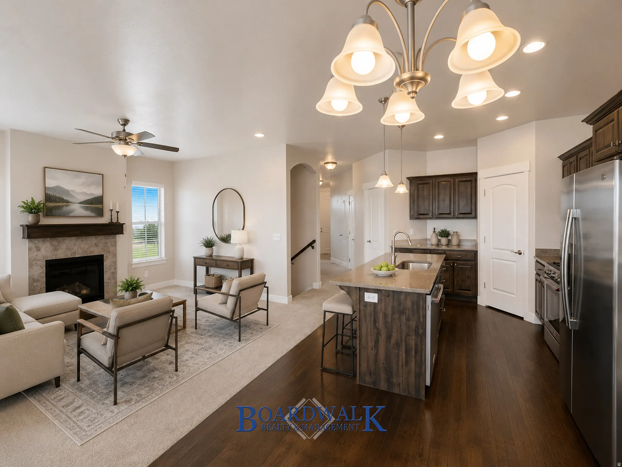 Open-concept living space with a fireplace featuring a stone surround and wood mantel
