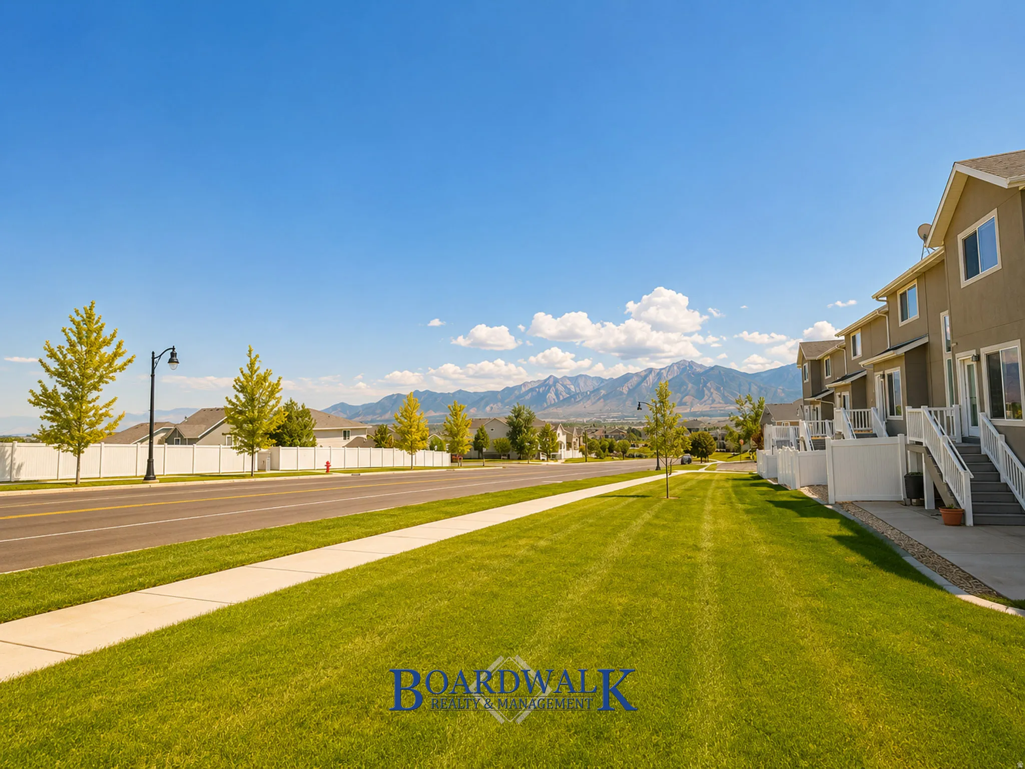 Townhome exterior featuring neutral stucco siding, white trim, and individual outdoor staircases