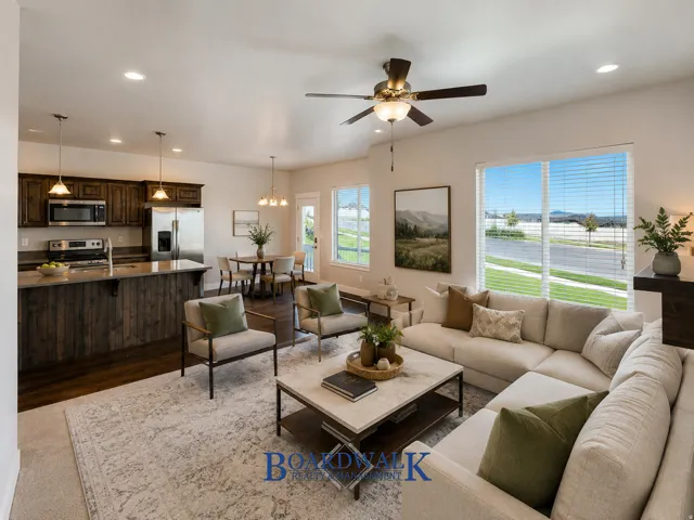 Open concept living area with wood-finish flooring