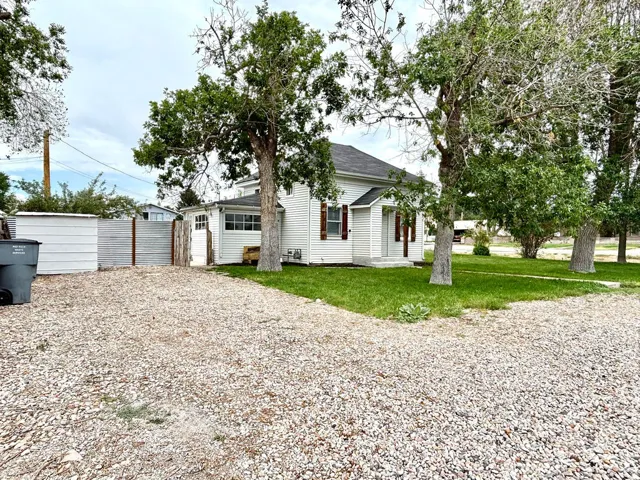 White siding residence with a covered porch entry